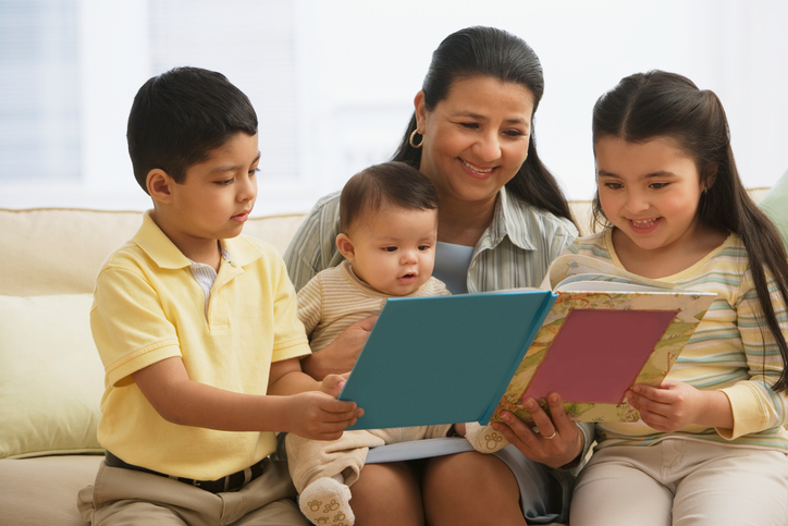 Hispanic mother reading to children