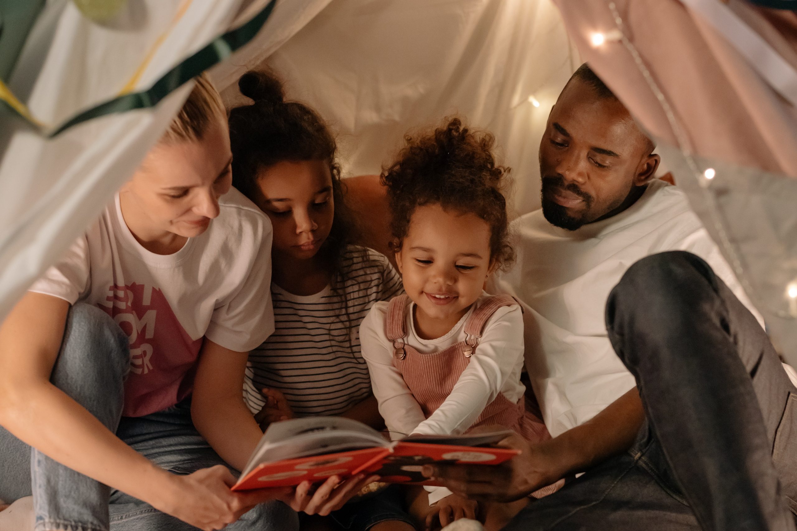 Photo by cottonbro studio: https://www.pexels.com/photo/a-family-reading-a-book-together-6668315/
